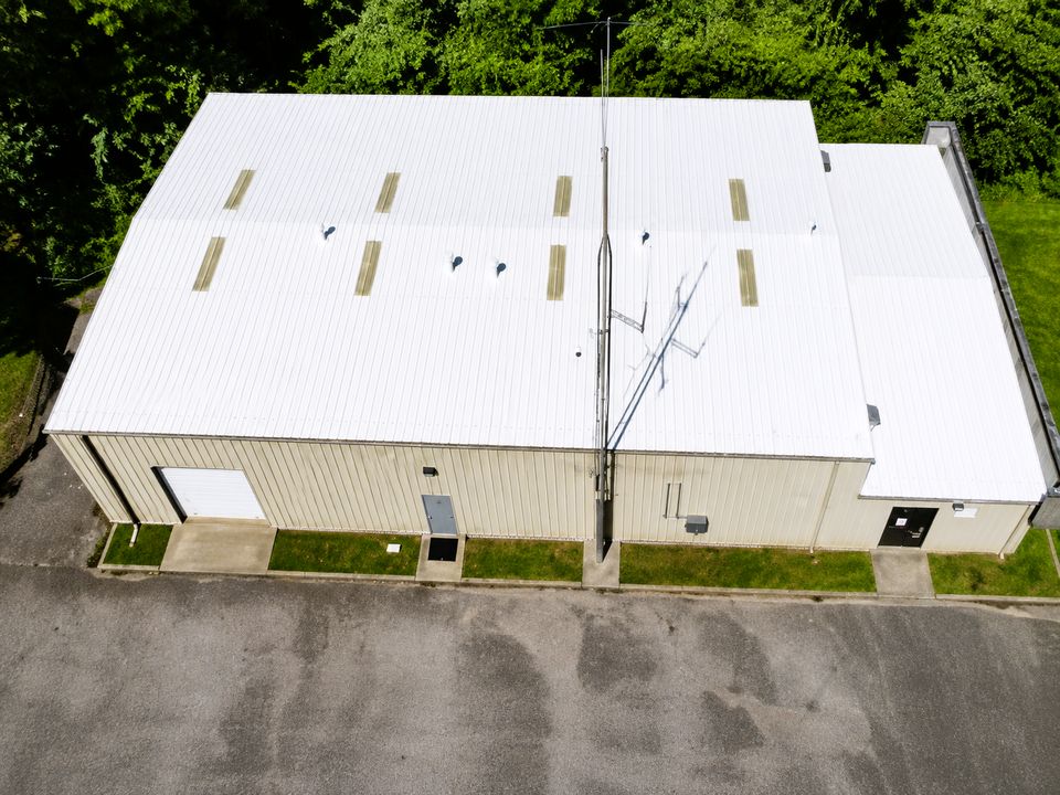 After: the same commercial metal roof in Bloomington, Indiana restored with a bright white Conklin reflective coating system