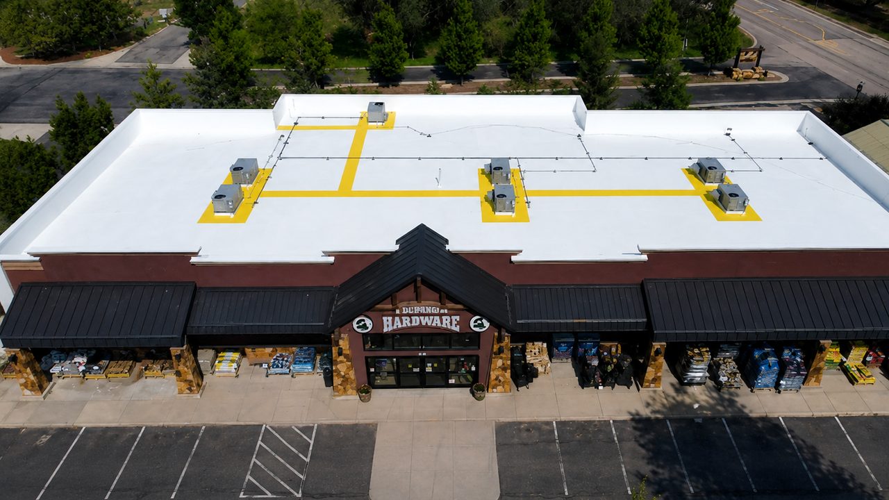 Retail store flat roof in Durango, Colorado coated with a Conklin white reflective system and marked service walkways